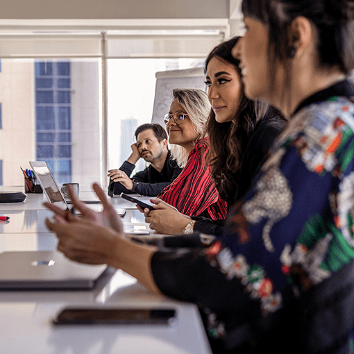 M+C Saatchi Employees at table in the office